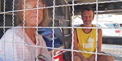 thailand sweden Two foreign overstayers sitting behind the mesh of a police truck in Phuket.
