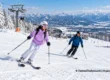 Two beginner skiers practising on a snowy slope at a mountain ski resort outside Thailand. AI-generated illustration.