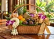 Festive Thai-style wicker gift basket with tropical fruit, jasmine, orchids and wrapped snacks. AI-generated illustration.
