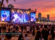 Photorealistic coastal concert with stage lights and beach audience, AI illustrative not a documented performance
