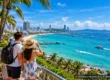 Sunlit coastal scene near Pattaya with beach, sea, palm trees and family-friendly daytime activities, AI-assisted editorial artwork