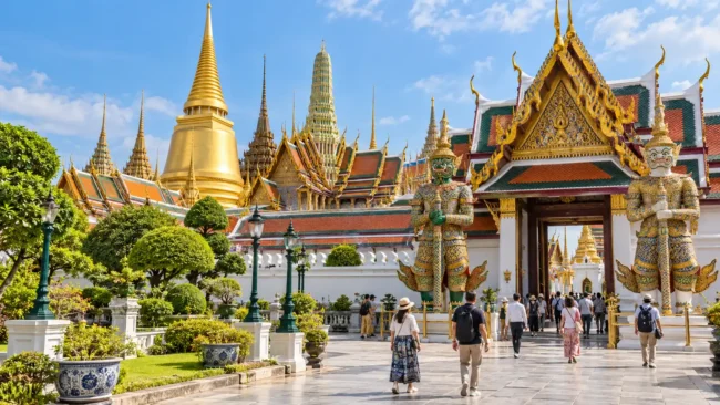 AI-generated illustration of the Grand Palace-style complex in Bangkok with tourists in the courtyard