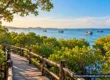 AI-generated conceptual view of a tropical Gulf of Thailand coastline with fishing boats and mangrove greenery