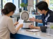 Woman holding a receipt while returning a rice cooker to a staff member at a shop service counter in Thailand. AI-generated image.